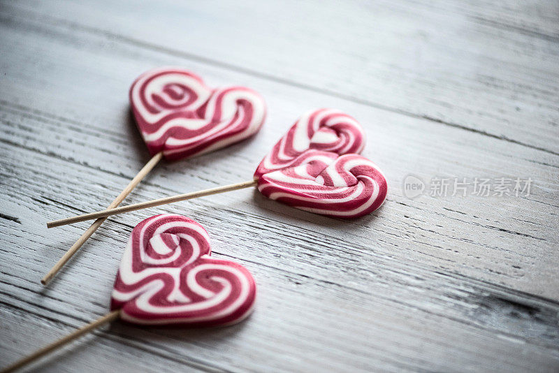 Heart Shape Lollipops on White Wooden Background, Valentine´s Day Concept